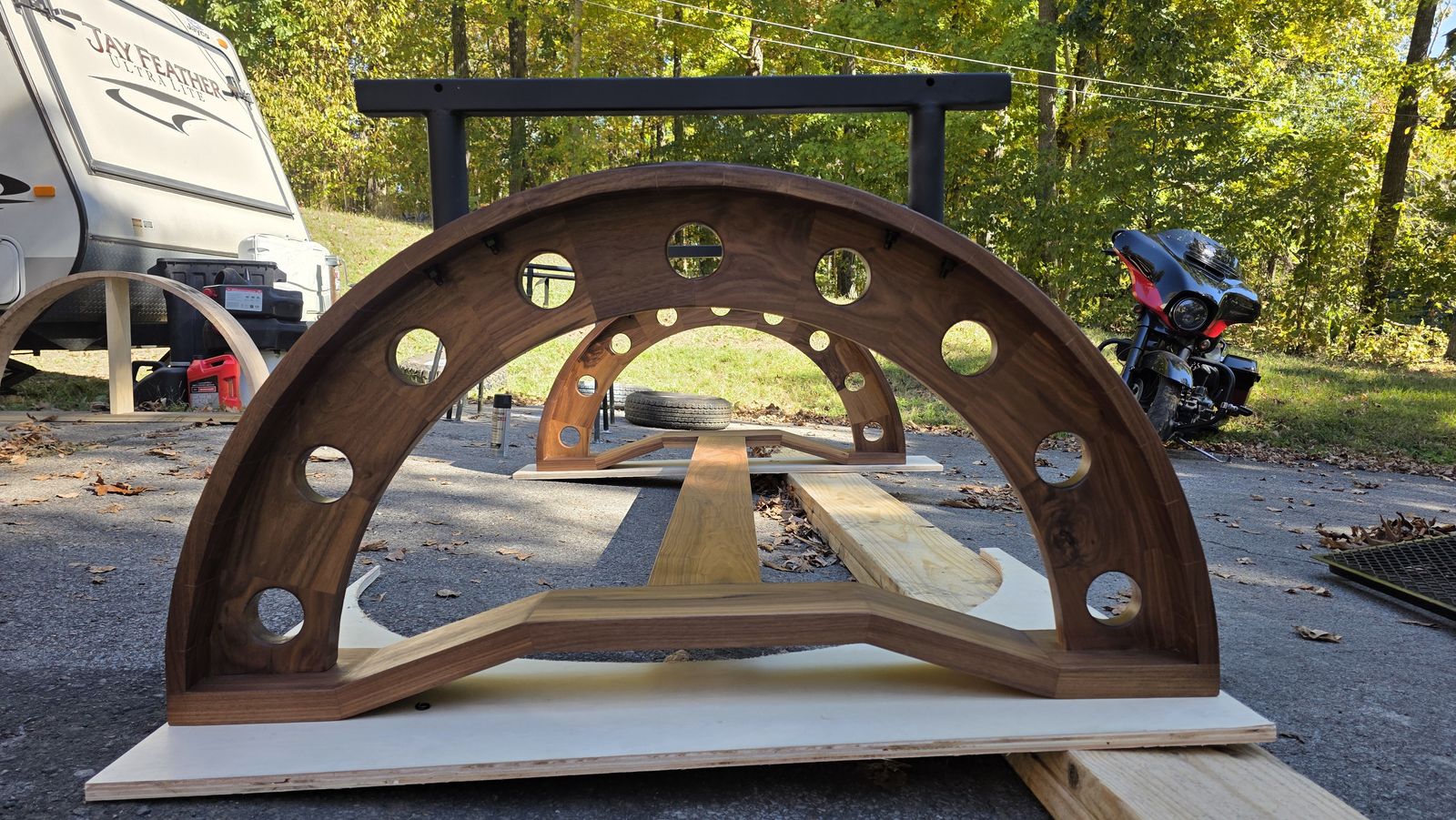 Black walnut arch base with circular cutouts for the 160th Chinook conference table, during the build