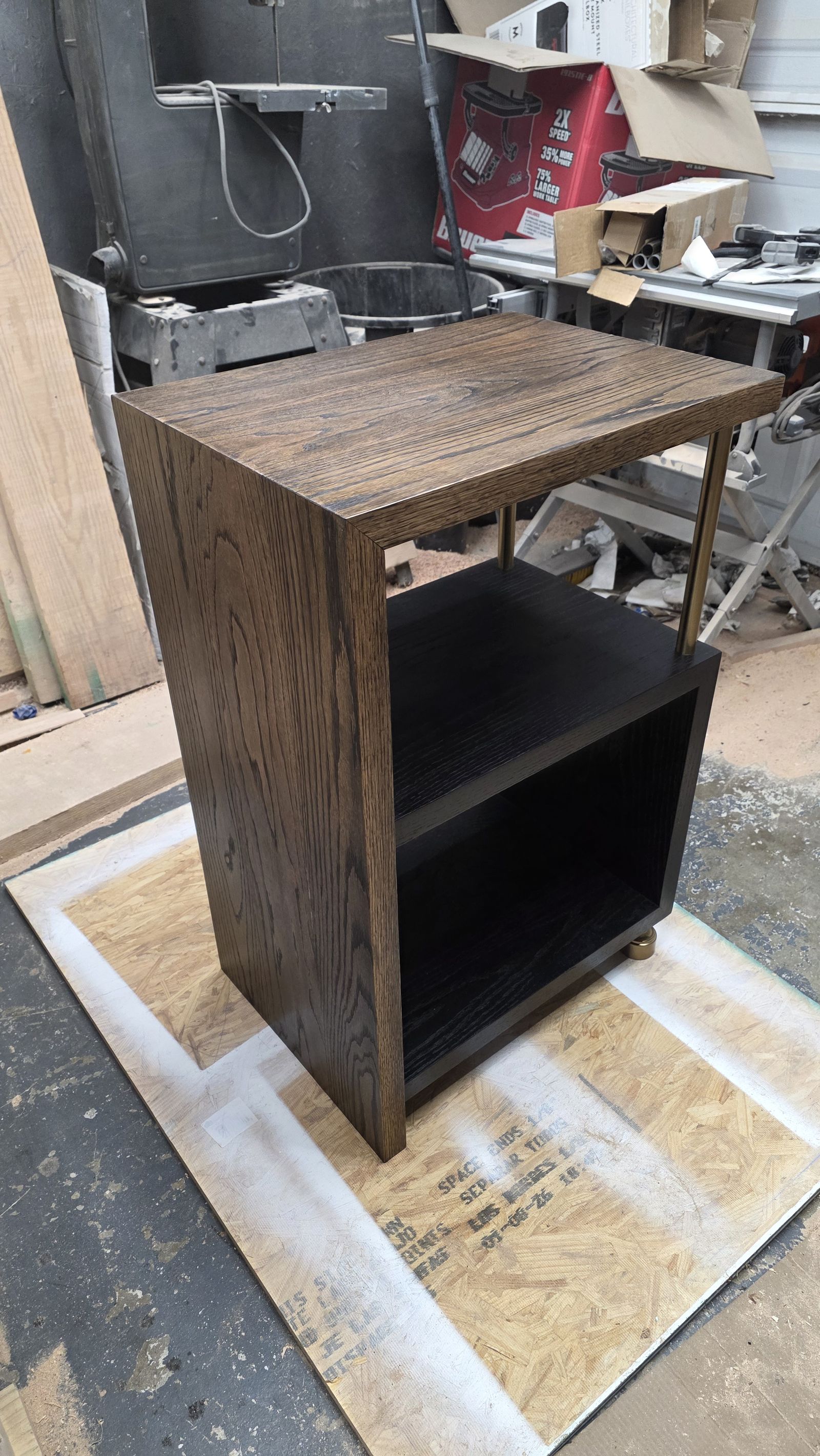 Red oak stereo stand in a dark custom stain, with a black painted cubby, photographed in the shop