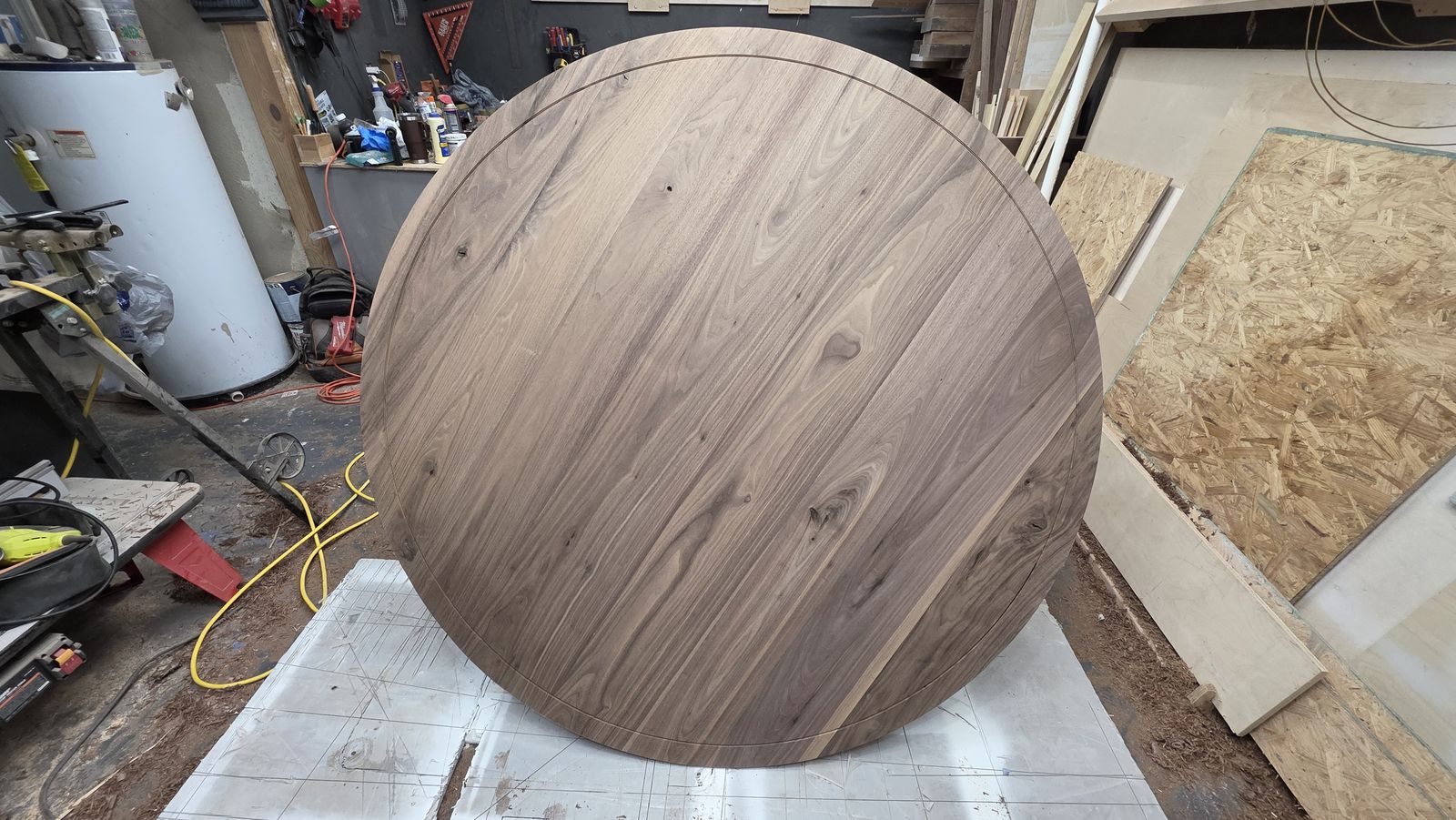 Brass strip being pressed into a routed channel in the walnut top